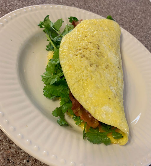 tips for healthier tacos include more vegetables and less bacon, such as in this egg omelet taco