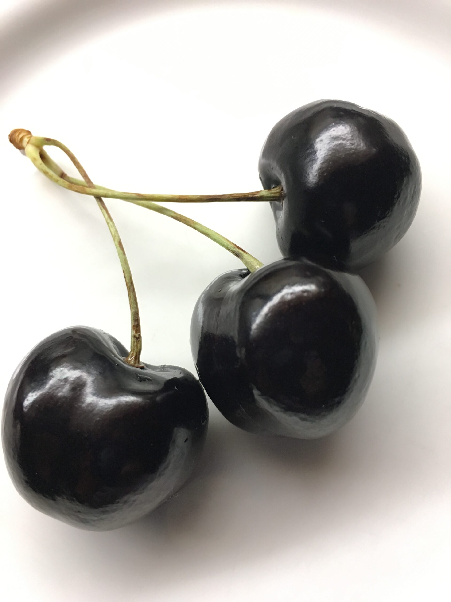 3 cherries on a plate